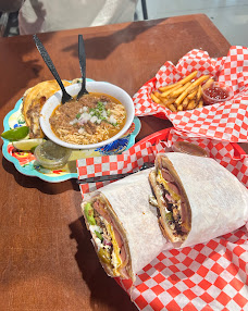 Burrito, fries and consomé spread